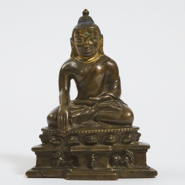 A Silver and Copper Inlaid Bronze Buddha, Tibet, 14th Century